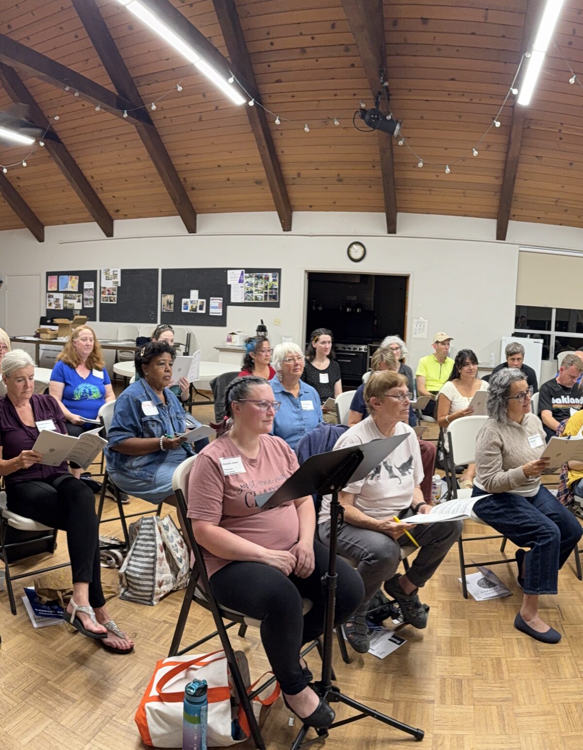 Choir members preparing music during an SDG rehearsal